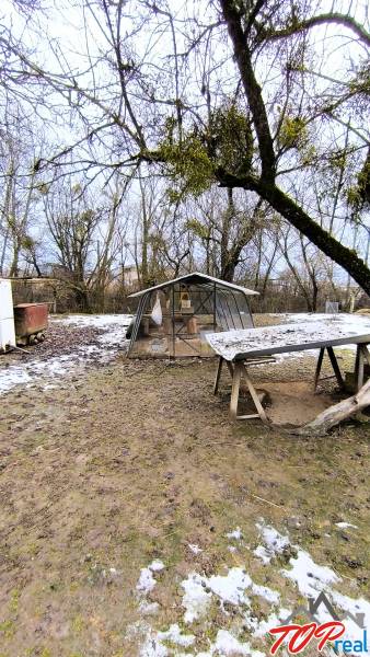 Snow-covered yard on Mierova Street in Krásnohorské Podhradie, plots - residential.