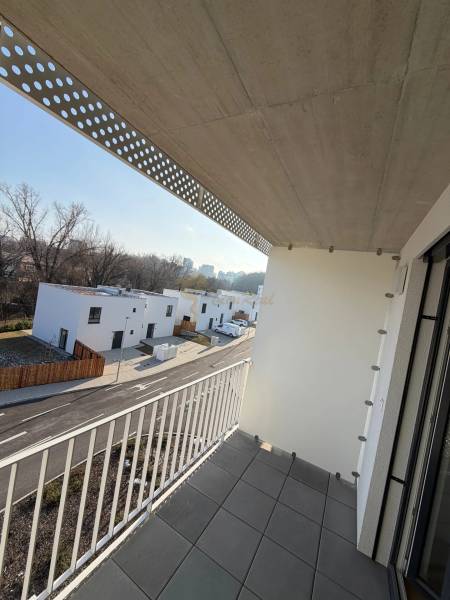 The balcony of a studio apartment on Agátová Street in Bratislava - Dúbravka with a view of modern houses.