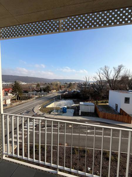 View from the balcony in Bratislava - Dúbravka on Agátová street with a road and houses.