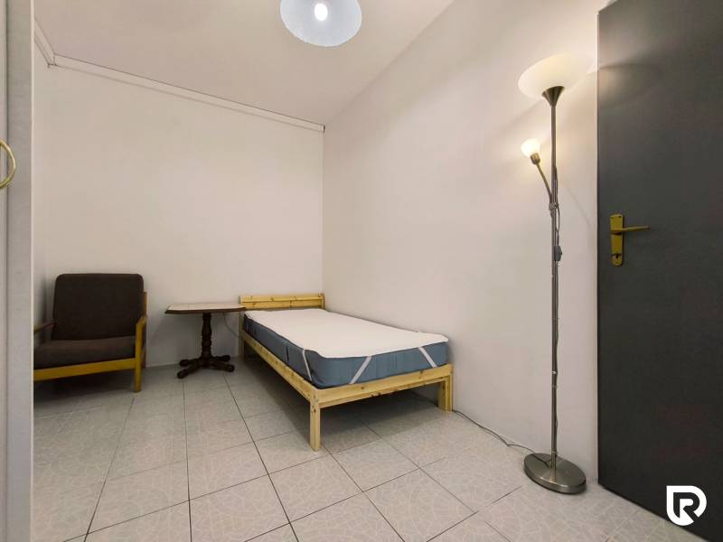 Single room with an armchair and a floor lamp in a family house.