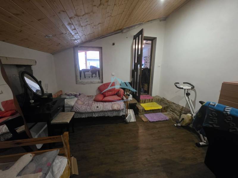One room in a family house with an exercise bike and a wooden decor floor.
