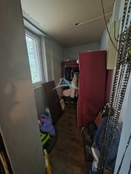 Storage space in a family house with a wooden decor floor and a lot of items.