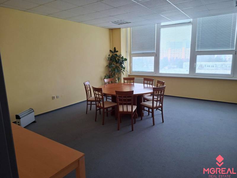 Meeting room with a round table and chairs in the office.