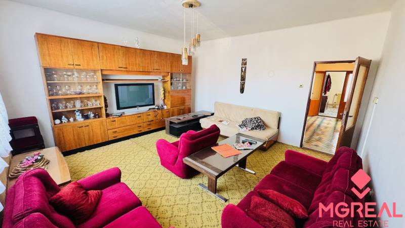 Living room in a family house with retro furniture and colorful armchairs.