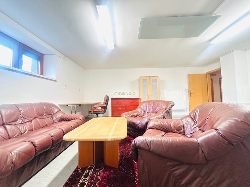 Leather sofa set with a coffee table, carpet, and work corner in a family house.