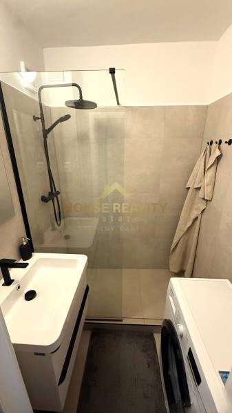 A bathroom with a spacious shower in a 3-room apartment.