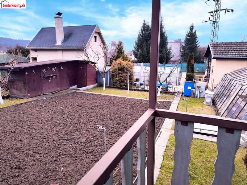 A yard with a house and garden in Partizánske, view from the balcony of the Cottage.