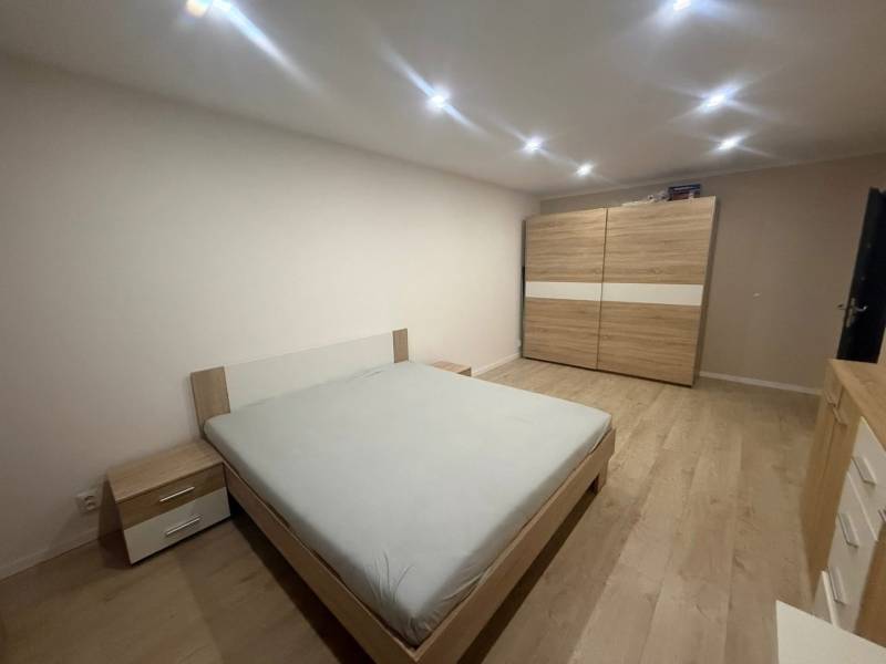 Bedroom in a 3-room apartment with wooden decor furniture, wooden decor flooring.