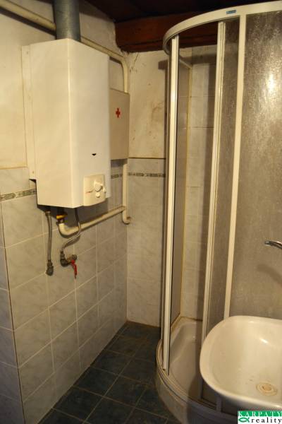 Shower enclosure with a gas boiler in the bathroom of a family house.