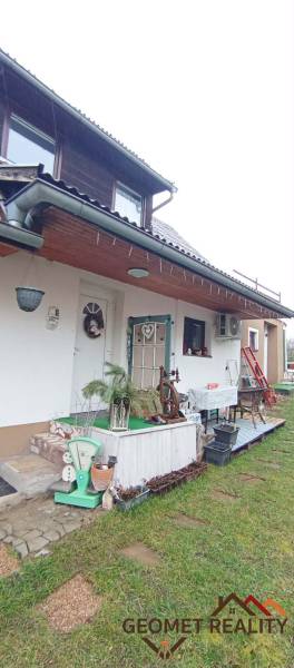 A family house on Cintorínska Street in Divín with outdoor seating and decorations.