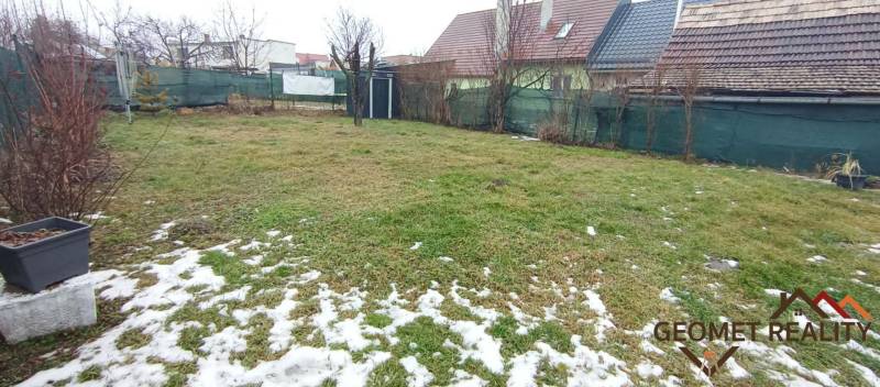 The garden at the family house on Cintorínska Street in Divín, covered with grass and snow.