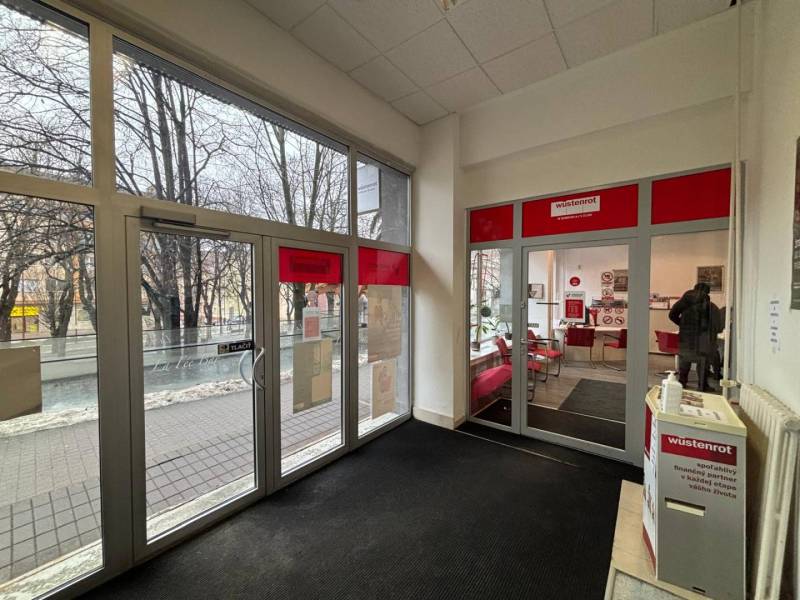Interior of commercial premises with a view of the street through glass doors.