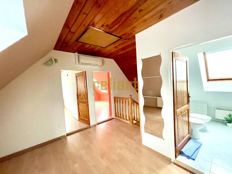 Interior of a family house with a wooden decor floor and a skylight.