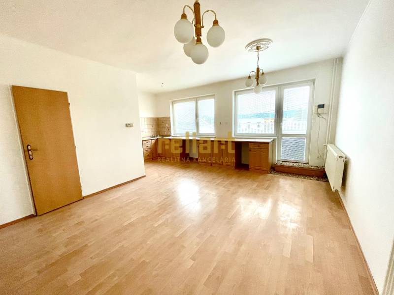 Living room with a kitchenette, wooden decor flooring in a family house.