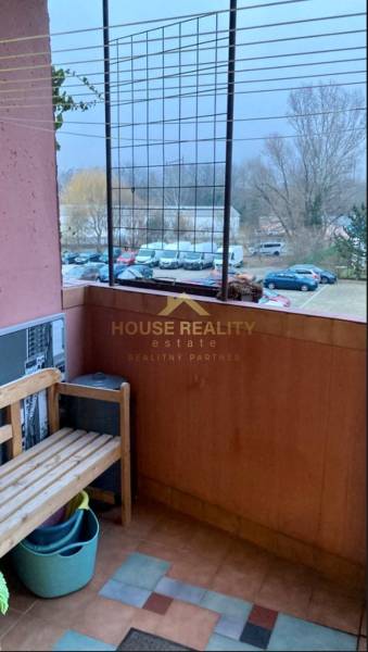 Balcony with a wooden bench, view of parked cars, Ján Poničan Street, Bratislava - Devínska Nová Ves.