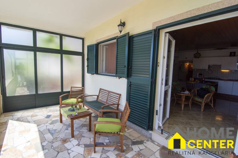 Terrace of a recreational apartment in Čiovo with comfortable seating and a view of the interior.