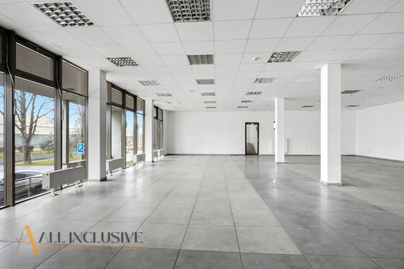 Spacious commercial spaces with large windows and tiles.