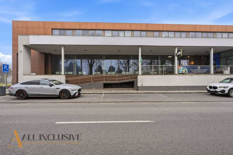 Commercial premises in Topoľníky with a modern building and parking in front of the entrance.