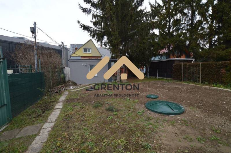 Garden cottage in Bratislava - Ružinov, Studená Street, surrounded by trees and fencing.