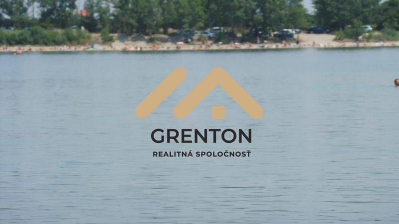 The logo of the real estate company Grenton with a view of a body of water by the coast.