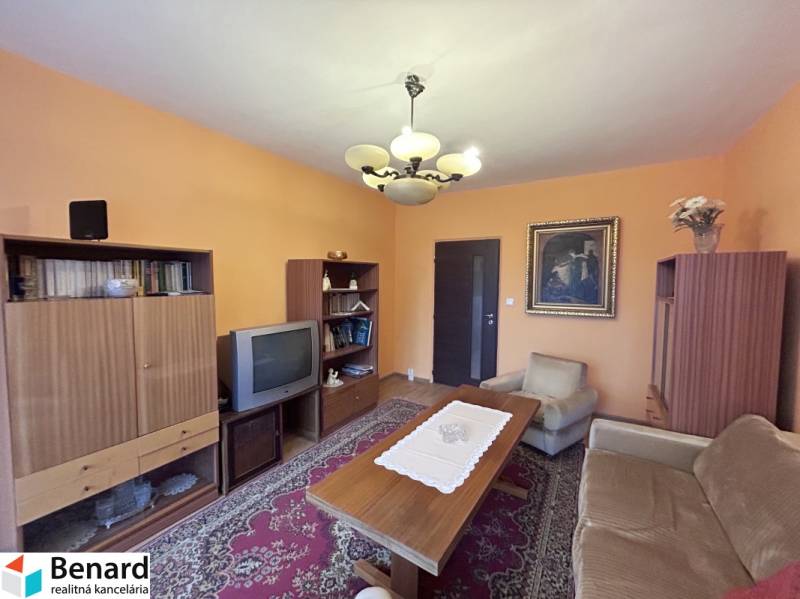 Living room with retro furniture in a two-room apartment, floor with wood decor, carpets.