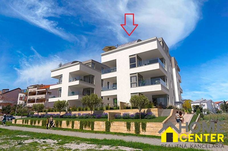A recreational apartment in the town of Pag with modern architecture, adjacent greenery, and comfortable balconies.