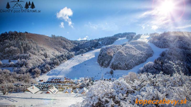 Snowy landscape in Mýto pod Ďumbierom at the Recreational Grounds, Fongrub with a ski slope.