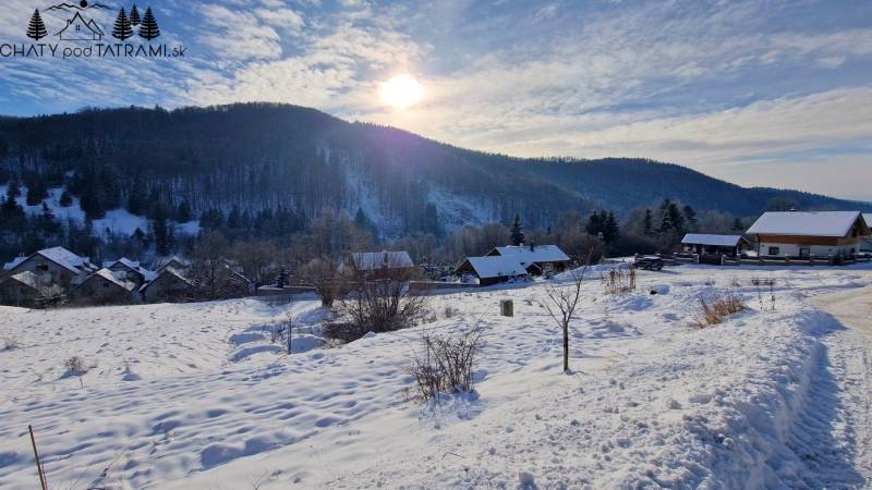Winter landscape at Recreational Grounds in Fongrube, Mýto pod Ďumbierom with snow-covered houses and forests.