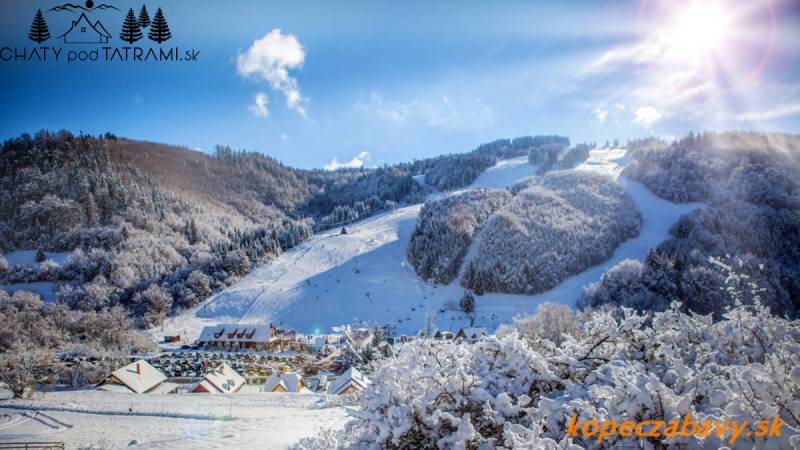 Snowy landscape, ski slope and cottages in Mýto pod Ďumbierom, ideal for living.