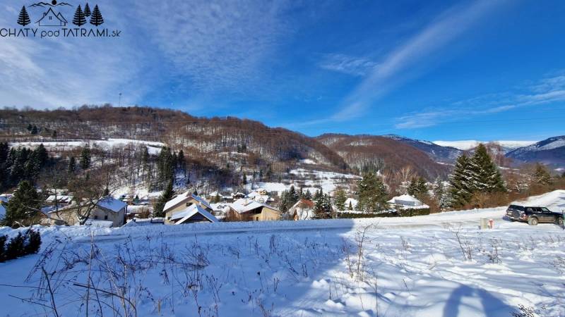 Snowy landscape in Mýto pod Ďumbierom with a view of residential plots.