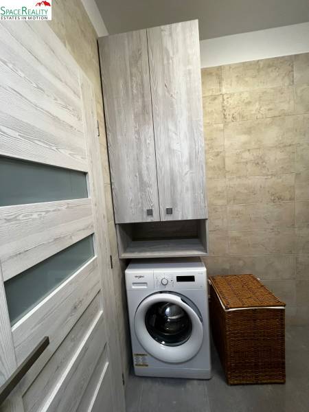 Washing machine with storage space in the bathroom of a 2-room apartment.