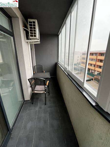 Glazed loggia of a 2-room apartment on Holubej Street in Senec with tiles and seating.