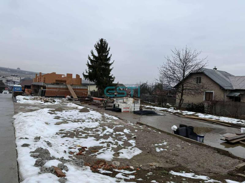 Construction site of a family house in Višňové on Višňová Street with snowy areas.