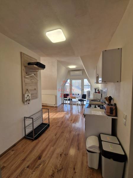 Interior of a family house with a kitchen and dining area, floor with wooden decor.