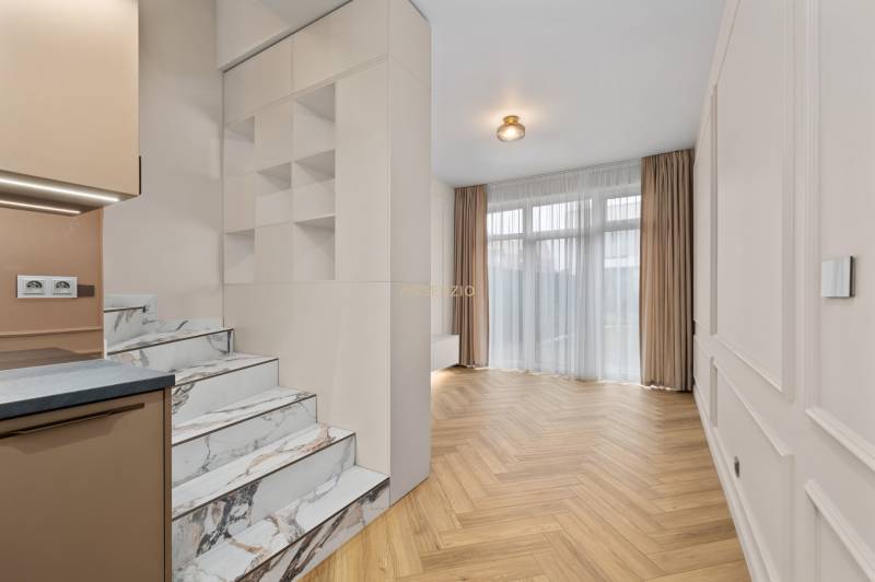 Interior of a 2-room apartment with marble stairs and a wooden decor floor.