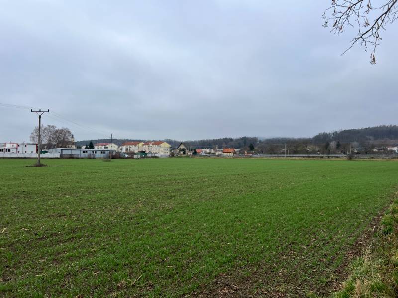 Lands - commercial in Pruské with a view of buildings in the distance and a field.