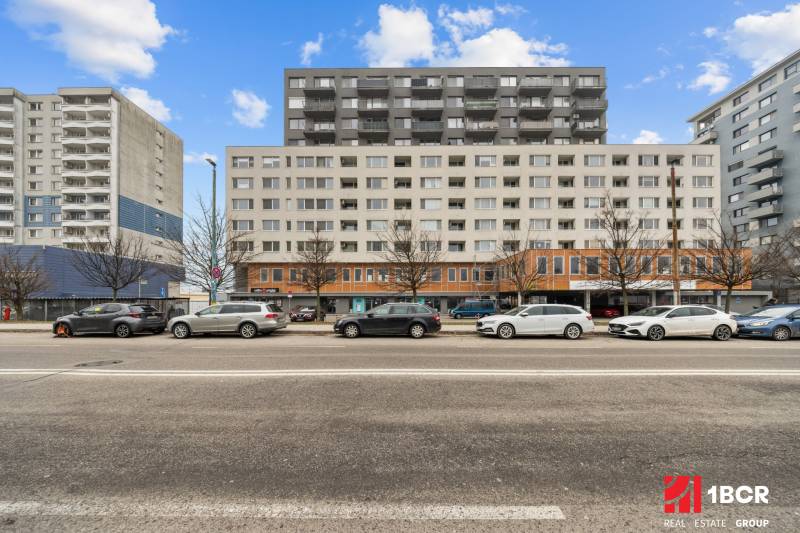 Building on Budatinská Street in Bratislava - Petržalka with cars parked in front of it.