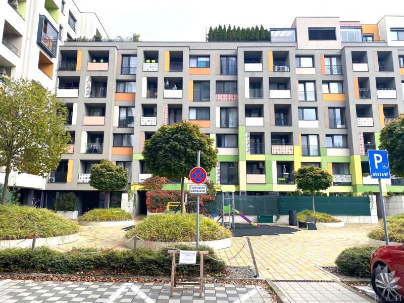 Colorful apartment buildings on Nejedlého Street in Bratislava - Dúbravka, with a parking space.