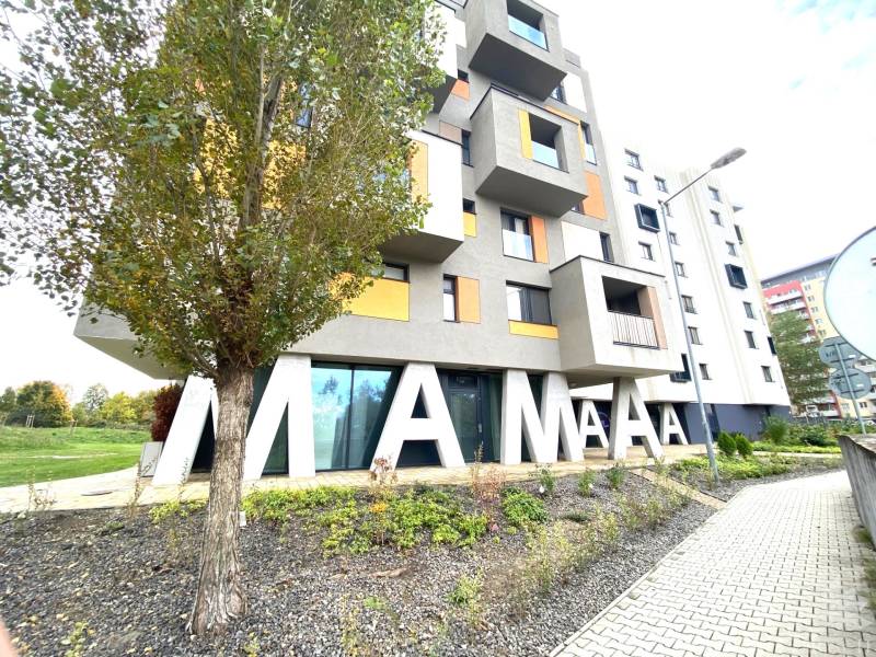 Building with a sign and a tree on Nejedlého Street in Bratislava - Dúbravka.