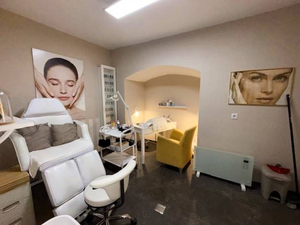 Commercial premises with chairs and wall decorations, floor with wooden decor.