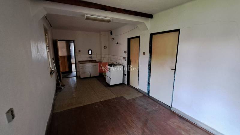 A kitchen in a family house with a wooden decor countertop and floor.