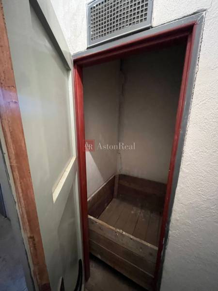 A small room with a wooden box in a 3-room apartment.