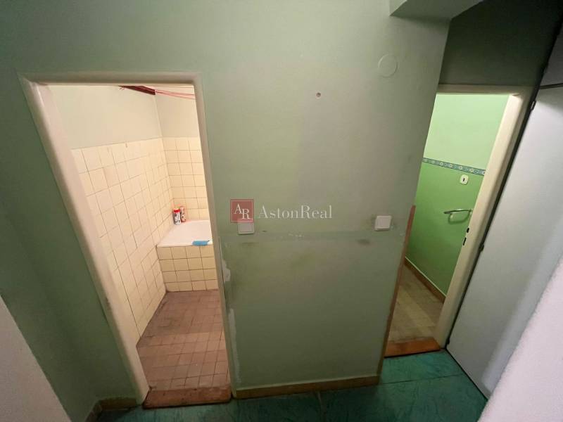 A hallway with an entrance to the bathroom and toilet in a 3-room apartment.