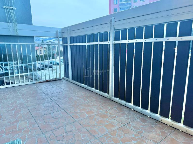 A balcony with a metal railing in a 2-room apartment, overlooking Centrum Street in Krásno nad Kysucou.