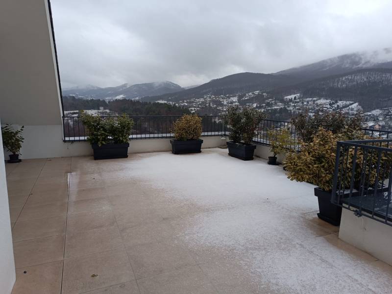 A snowy terrace in Nová Baňa on Pod sekvojou Street with a mountain view.