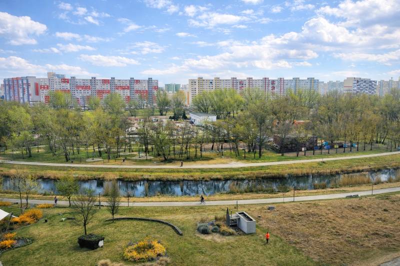 Petržalka, Bratislava: View of the housing estate through the park and watercourse near Rusovská Road.