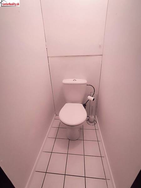 White toilets with a tiled floor in a 2-room apartment.