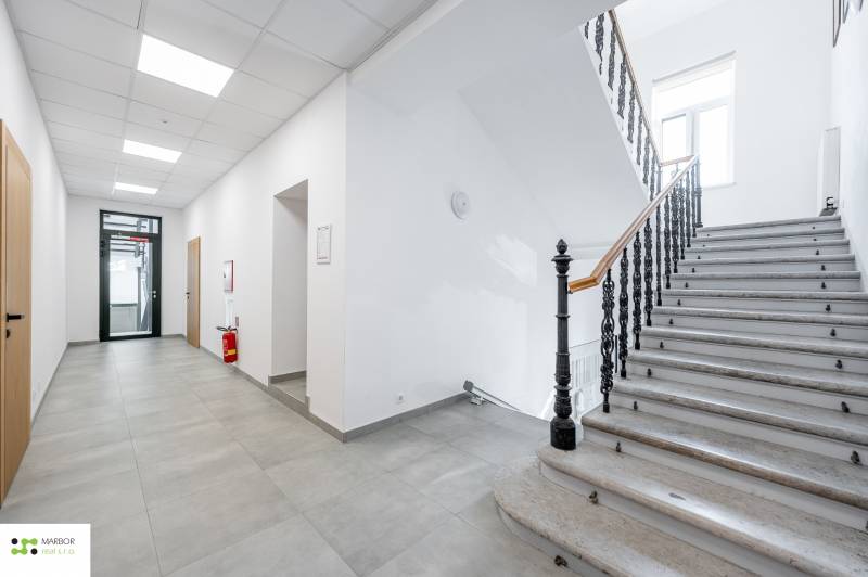 Interior with a stone staircase and hallway.