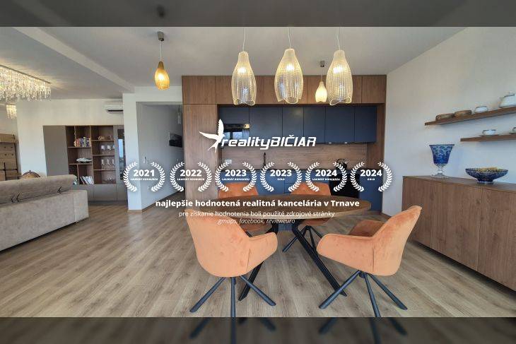 Interior of a holiday apartment with a wooden decor floor and a dining table.