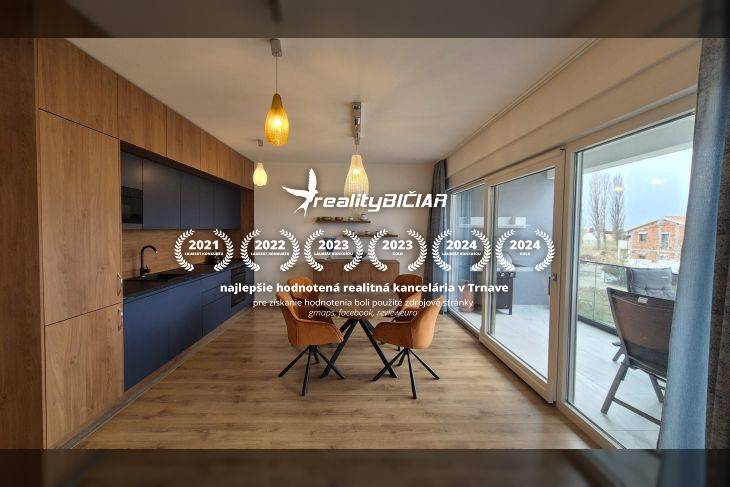 Dining area with wood-patterned flooring and large windows in a holiday apartment.